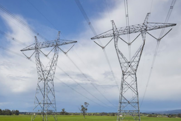 Twin transmission towers in a green field