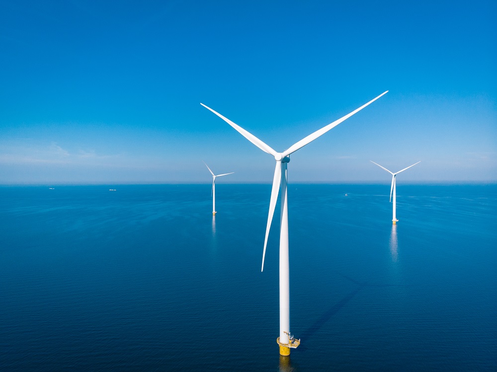 Three wind turbines in the ocean  